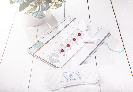 白色桌面上的卫生女性卫生用品背景图片