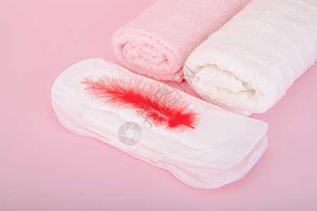 羽毛女人粉色背景上的卫生巾背景