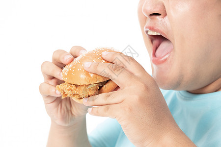 肥胖男士大口吃汉堡高清图片