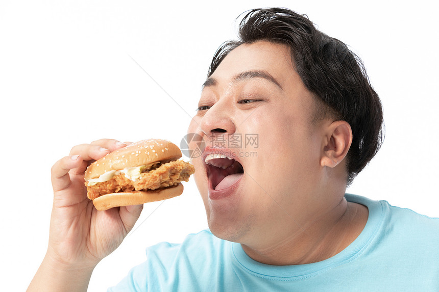 肥胖男士大口吃汉堡图片