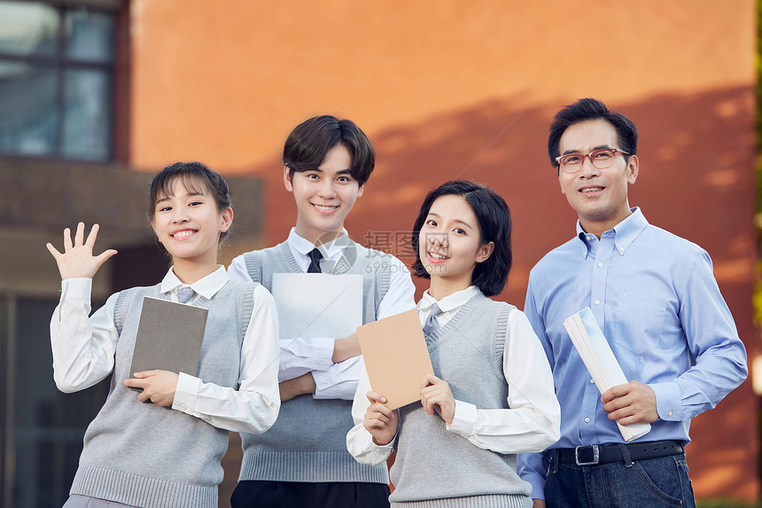 高中校园里老师和学生们拿着书合影图片