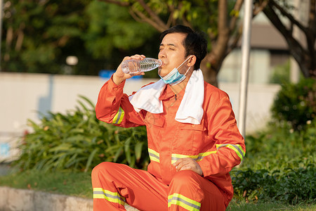 男性清洁工形象在马路旁喝水休息的环卫工人背景
