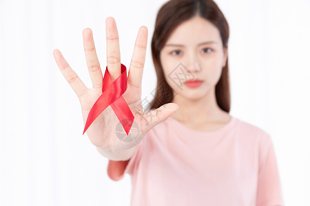 红色艾滋病标志红丝带关爱艾滋病患者背景