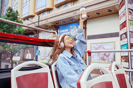 欢呼的女孩坐观光大巴旅游伸手欢呼的年轻女孩背景