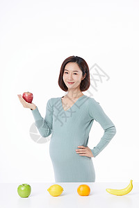 孕妇橙汁怀孕的人手拿苹果背景