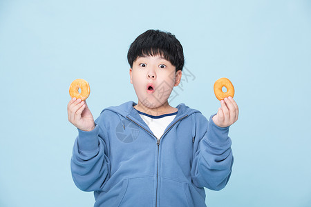 喜欢吃甜甜圈的小男孩吃甜食的人背景图片