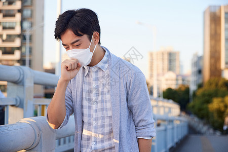病毒性肺炎户外带着口罩咳嗽的男性背景