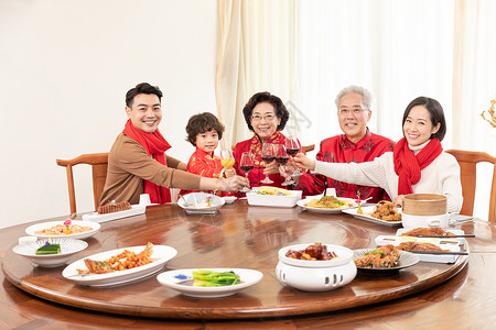 除夕夜团圆吃年夜饭的一家人干杯庆祝背景图片