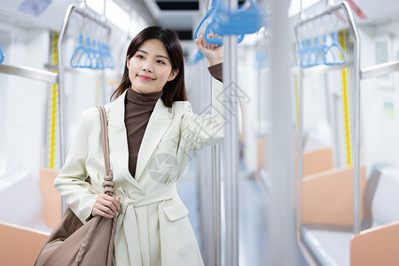 微笑的乘坐地铁的女性图片