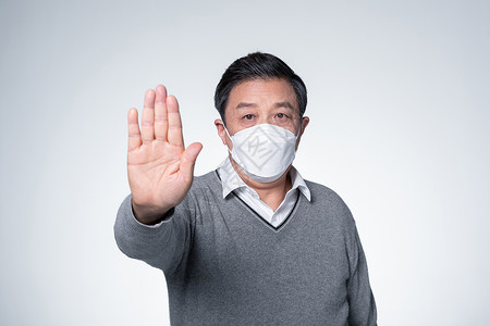 传染预防戴着口罩的老人做禁止手势背景