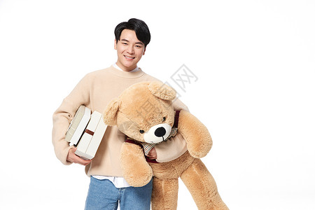 阳光韩系男生抱着毛绒玩具熊高清图片