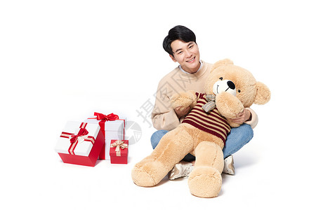 阳光韩系男生抱着毛绒玩具熊高清图片