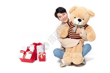 阳光韩系男生抱着毛绒玩具熊图片