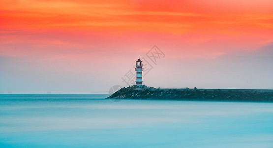 海岸灯塔素材晚霞夕阳下的海边灯塔背景