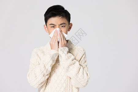 青少年男生生病捂住口鼻背景图片