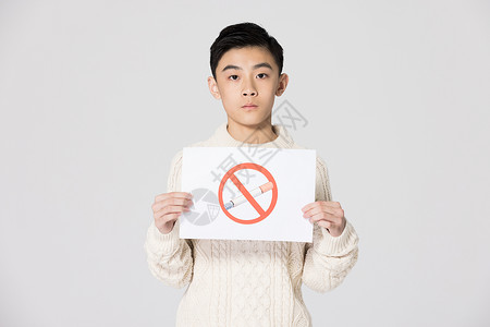 禁止吸烟的标志青少年儿童手举禁止吸烟标志背景