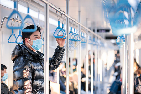 疫情期间的深圳地铁乘客疫情期间乘坐地铁的男性形象背景