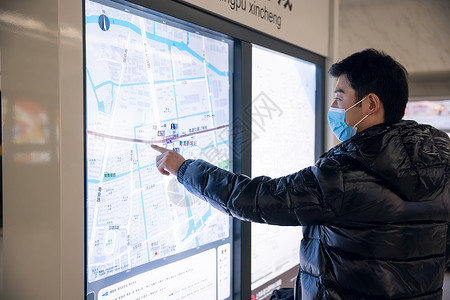 牛年春节防疫海报查找地铁站台信息的男性背景