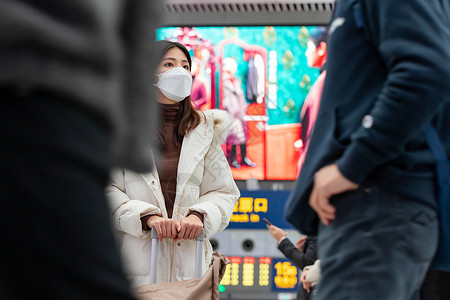 在火车站人群中等待的女性图片