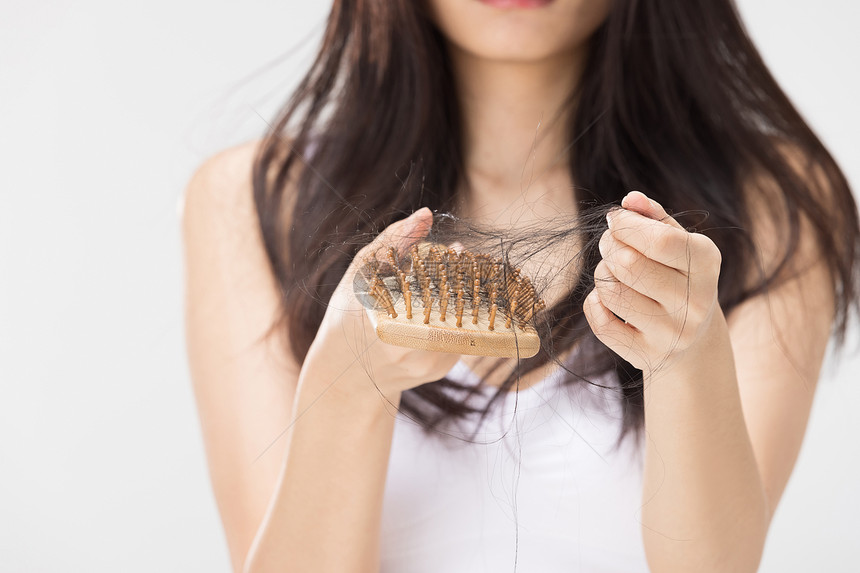 女性梳头掉发烦恼特写图片