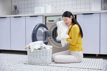 室内洗衣机做家务的女性整理清洗脏衣物背景