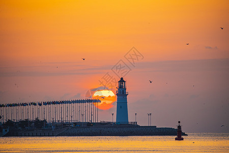 朝气蓬勃灯塔与海上日出背景