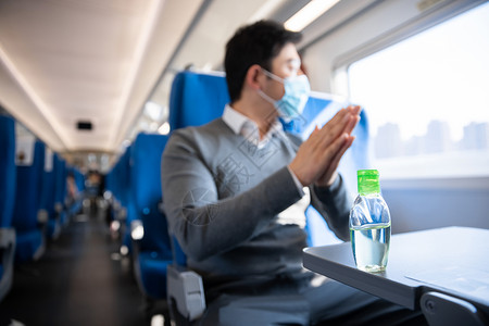 在列车上使用消毒酒精的男性高清图片