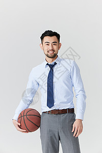 单手抱着篮球的职场男性图片