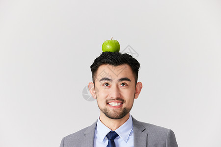 男性头顶着一颗苹果高清图片