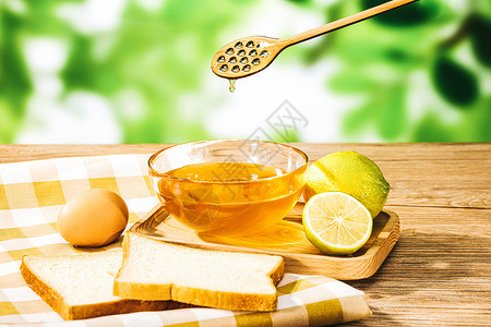 美味柠檬木桌上的蜂蜜和蜂蜜水背景