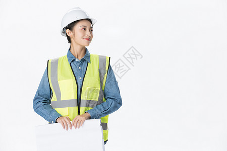 安全帽美女青年女性建筑工程师拿设计图纸背景