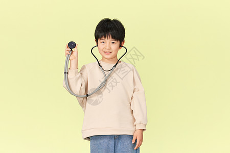 拿着听诊器的小男孩背景图片