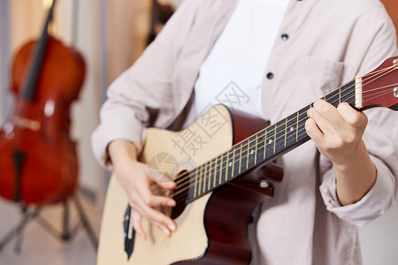 弹吉他的女性手部特写图片