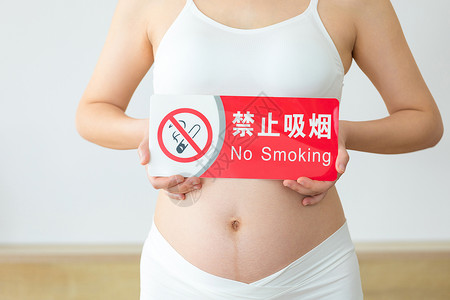 烟标志拿着禁烟标识的孕妇特写背景