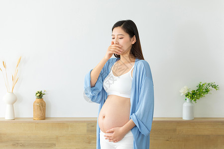 捂着嘴的孕妇反胃的人背景图片