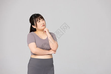 胶衣穿着健身衣的肥胖女性思考形象背景