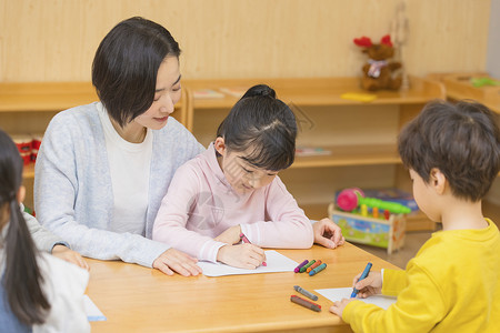 儿童识字幼儿园老师教小女孩写字背景