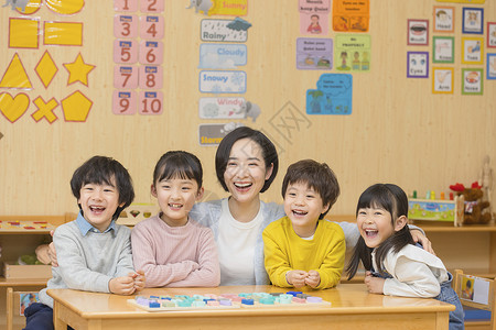 老师微笑幼儿园的老师与儿童背景