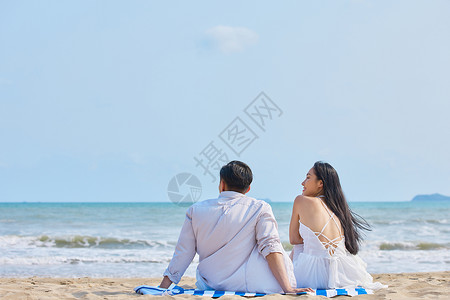 看海的人年轻情侣坐在沙滩看海背影背景