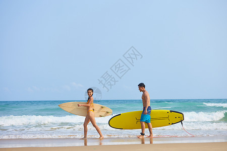 情侣性感青年男女拿着冲浪板海边聊天背景