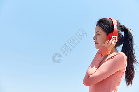跑步听音乐青年女性跑步运动戴耳机休息背景