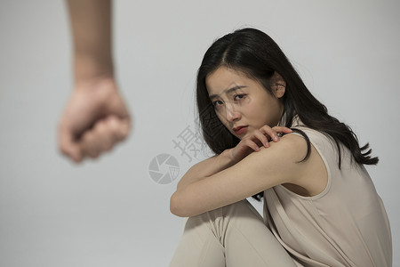 在拳头下恐惧的女性背景图片