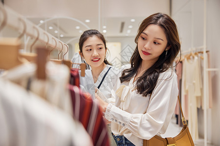 美女模特和衣服女性和闺蜜一起到商场选购服装背景