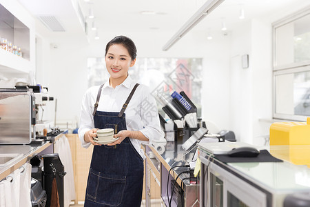 饮品店女性服务员端着咖啡背景图片