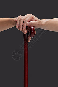 红色木槌关爱老人手部搀扶拐杖特写背景
