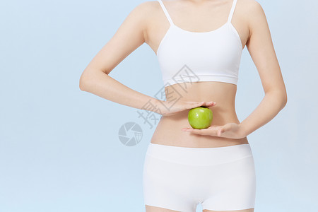 青苹果健康饮食减脂健身青年女性手拿青苹果背景