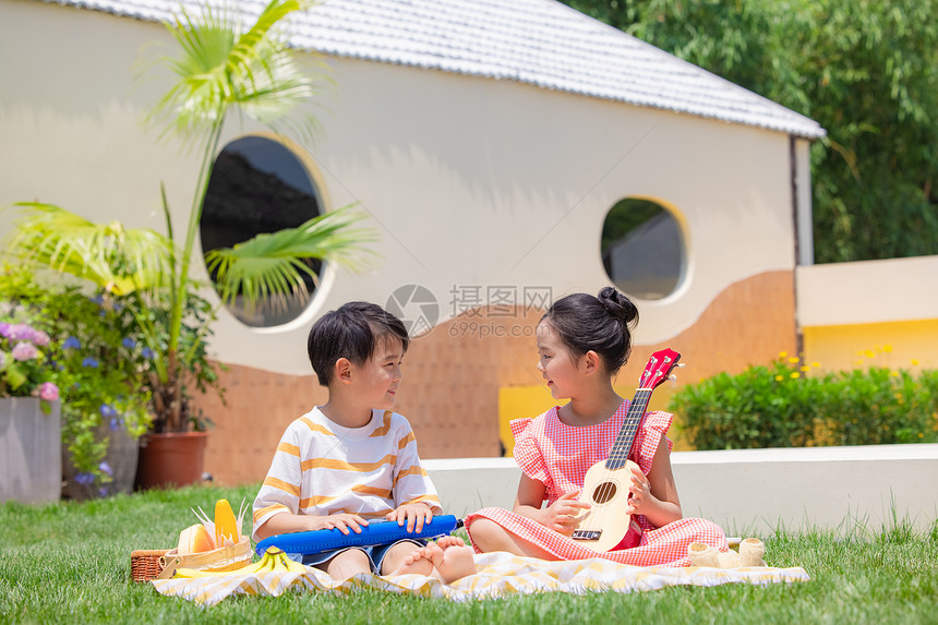 小男孩小女孩野餐玩尤克里里图片