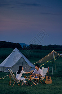 一家人晚餐年轻情侣夜晚户外野营背景