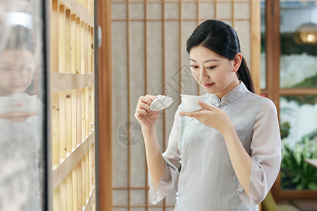 气质美女品茶背景图片