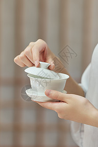 女性端着茶杯手部特写背景图片